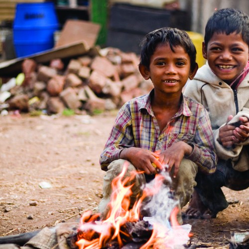 Children by a fire.